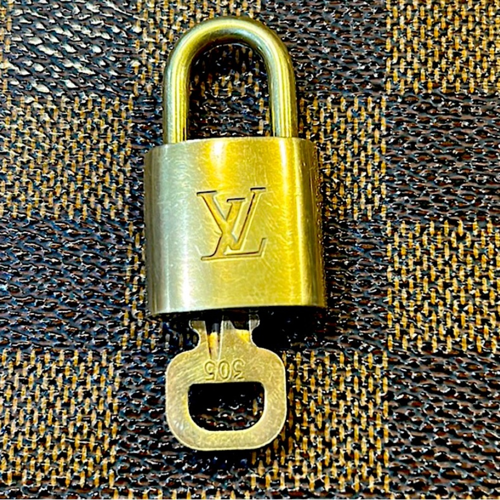 Louis Vuitton padlock and key. Unisex